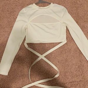 A tight white long sleeve crop top with ties !!